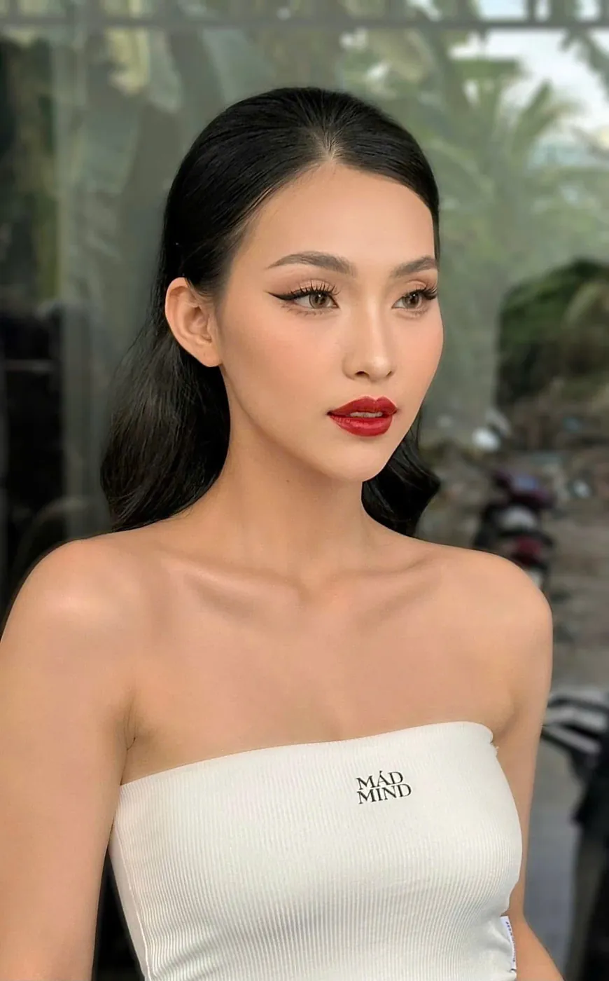 Classic glam makeup with a red lip and sleek hair